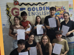 Students and a teacher celebrating exams with certificates in front of an institute banner.